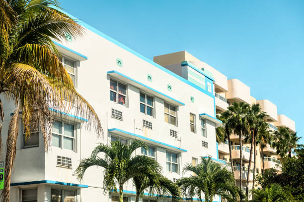 white, blue, teal, turquoise, yellow buildings in art deco district in south beach of miami, florida during sunny day with palm trees, balconies, windows - art deco miami florida florida apartment imagens e fotografias de stock