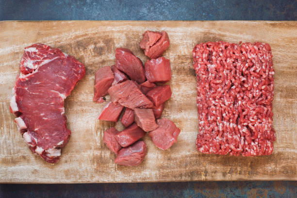 Grass fed raw angus beef meat. Different cuts of raw fresh angus beef meat Grass fed raw angus beef meat. Different cuts of raw fresh angus beef meat: sirloin steak, ground and chopped meat on a wooden cutting board grass fed stock pictures, royalty-free photos & images