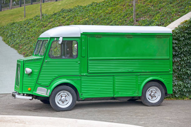 Paris, France - June 22 2018: Left side view of a Green Citroen H Van pre-1969 model with semi-circular rear wings and suicide doors.