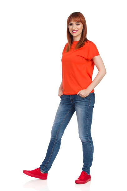 istock Young Woman Is Standing Relaxed With Hands In Pockets And Smiling 1053203968