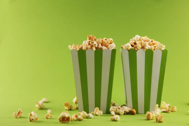 istock Cinema concept with popcorn in green white bag. 1053205704