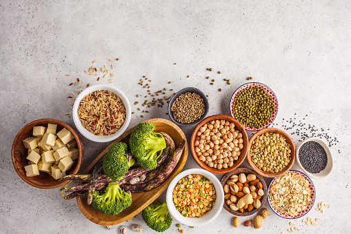 Vegan protein source. Tofu, beans, chickpeas, nuts and seeds on a white background, top view, copy space. Healthy vegetarian food concept.