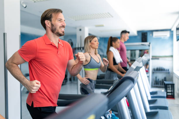 istock Group of young athletes jogging on treadmills in a gym 1053210932