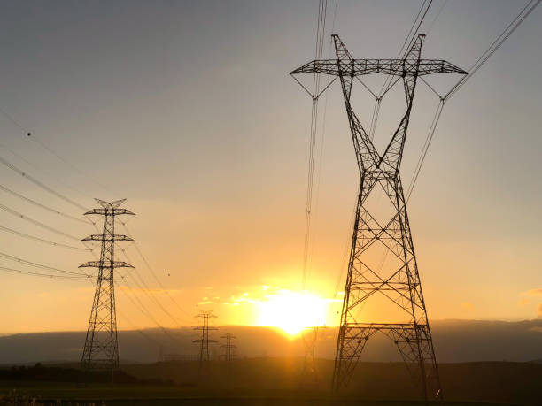 istock Electric power lines at sunset 1053212688