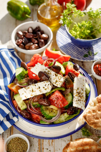 Greek salad. Traditional Greek salad consisting of fresh vegetables such as tomatoes, cucumbers, peppers, onions, oregano and olive oil. Greek salad. Traditional Greek salad consisting of fresh vegetables such as tomatoes, cucumbers, peppers, onions, oregano and olive oil. A delicious and healthy vegetarian dish greek food stock pictures, royalty-free photos & images