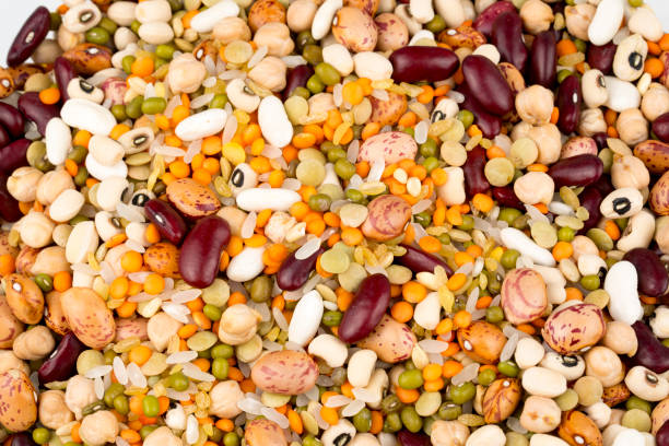 istock Mixed dried legumes and cereals isolated on white background, top view 1053219356