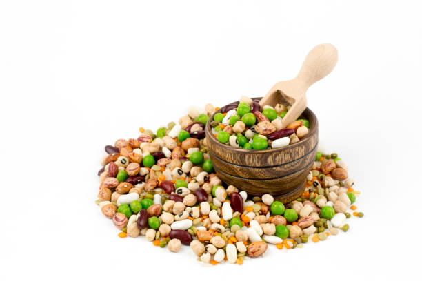 istock Mixed dried legumes and cereals isolated on white background, top view 1053219800
