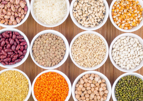 istock Mixed dried legumes and cereals isolated on white background, top view 1053222980
