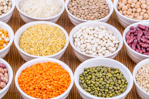 istock Mixed dried legumes and cereals isolated on white background, top view 1053223134