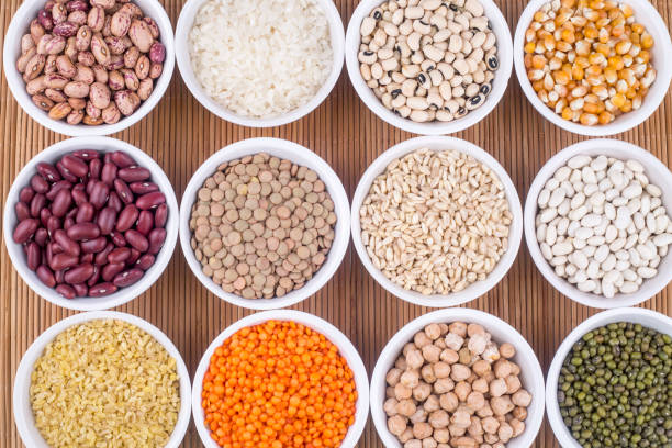 istock Mixed dried legumes and cereals isolated on white background, top view 1053223146