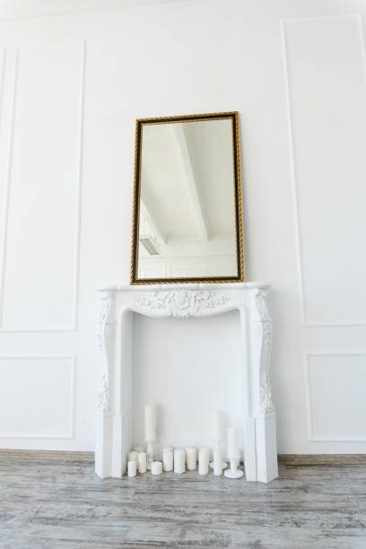 istock white fireplace with a mirror above it in an empty room 1053226914