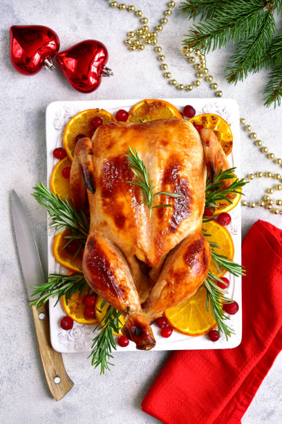 istock Roasted chicken with oranges ,rosemary and cranberries 1053228990