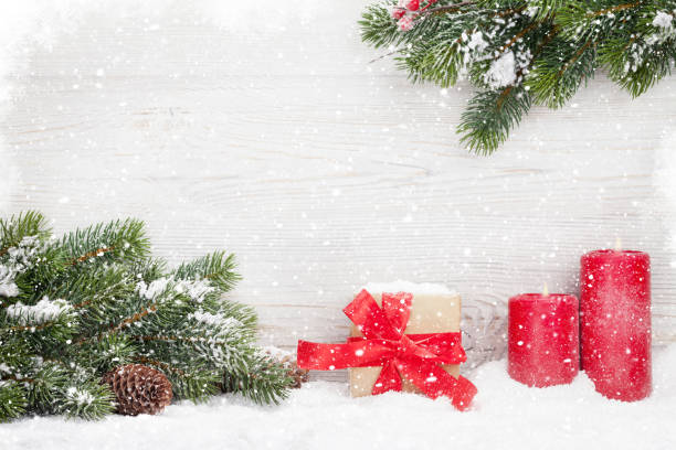 istock Christmas gift box, candles and fir tree 1053229234