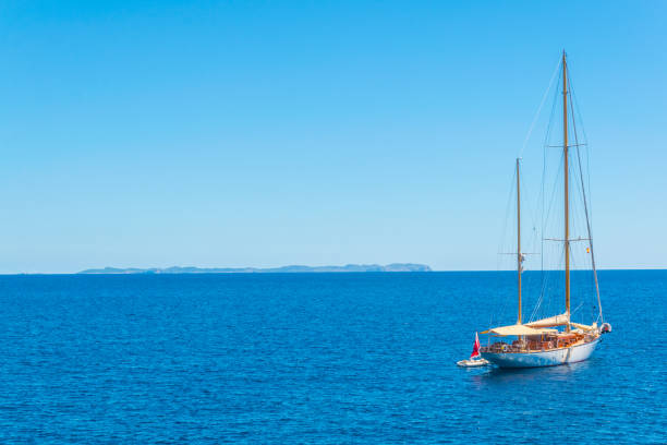 istock Yacht with Ibiza island at background, Spain 1053234468