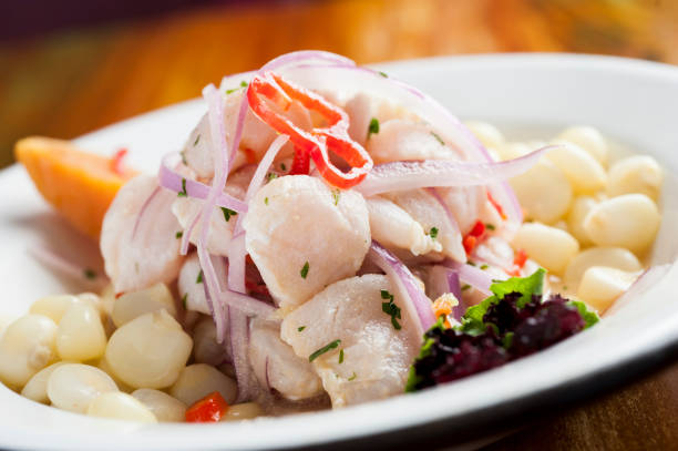 Ceviche, dish symbol of Peruvian gastronomy. Ceviche, dish symbol of Peruvian gastronomy. On a wooden table. peruvian culture photos stock pictures, royalty-free photos & images