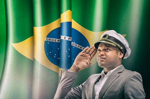 Boat Captain Saluting in front of brazilian flag
