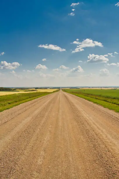 A Straight Dirt Road into the PlainsA dirt road heading straight to the horizon in the Great Plains of Saskatchewan, Canada