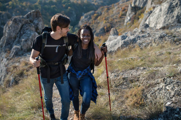 istock Young couple hiking on mountain trail 1053240806