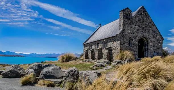 The stone church on the shore of Lake Tekapo in New Zealand. The water is an amazing blue because of the powder in the water caused by the grinding of rocks due to glacial action.