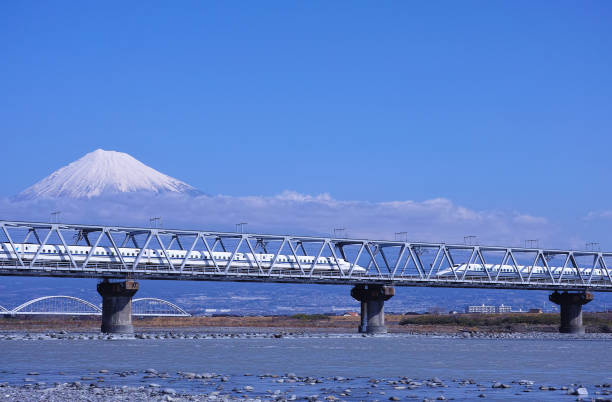Mount Fuji and the Fuji River Iron Bridge Shizuoka, Japan-March 12, 2018: Fuji River iron bridge over Fuji River in Fuji City, Shizuoka Prefecture. From here, you can see Fuji River and Mt. Fuji better. And, the high - speed railway runs this iron bridge all the time. bullet train mount fuji stock pictures, royalty-free photos & images