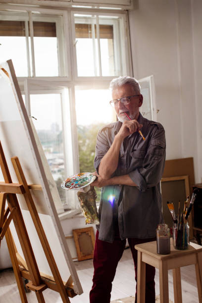 istock Senior man painting 1053257950