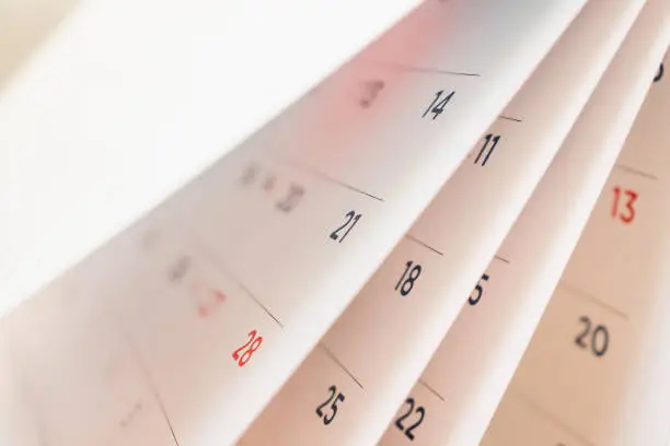 Photo of Abstract blur calendar page flipping sheet close up background