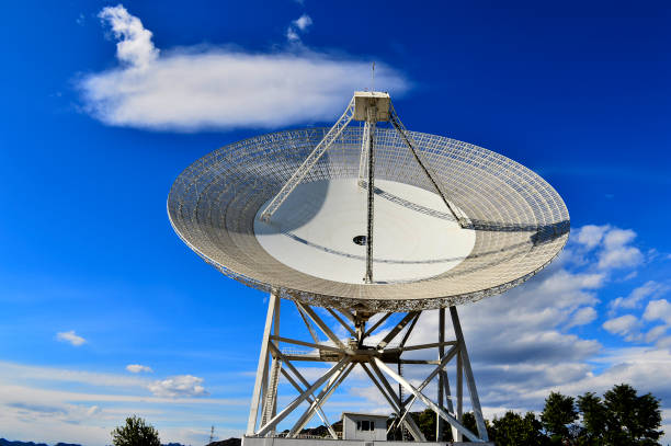 istock Array of satellite dishes or radio antennas against sky. Space o 1053261702