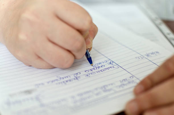 istock woman writing on paper 1053267842