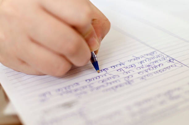 istock woman writing on paper 1053267846