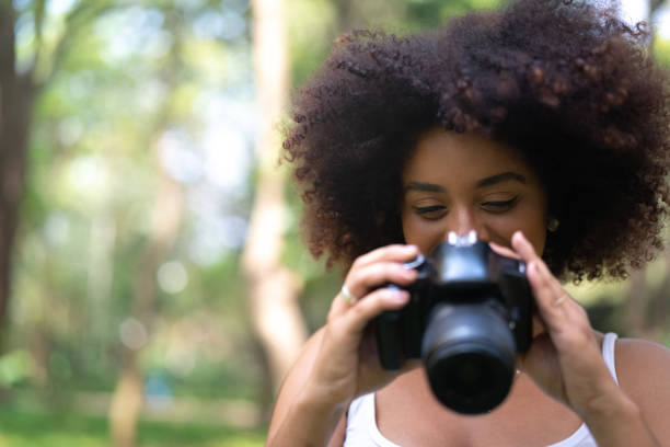 istock Woman taking photo at park 1053277690