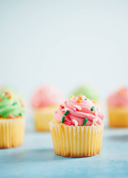 istock Pastel cupcake background in green and pink 1053277892