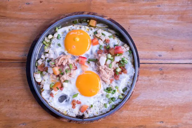 pan-fried egg on wood table