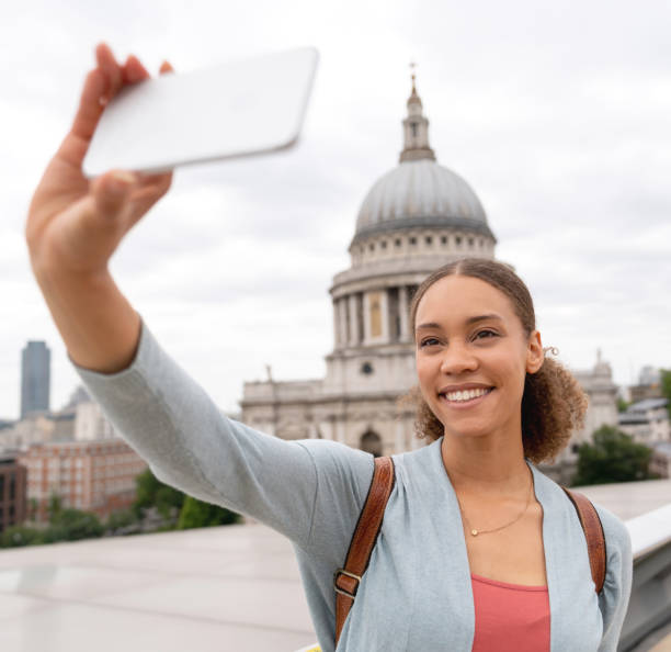 istock Happy woman taking a selfie while sightseeing in London 1053290530