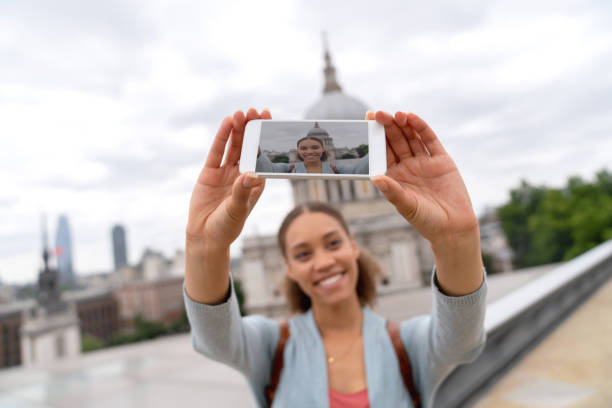 istock Happy woman taking a selfie while sightseeing in London 1053290532