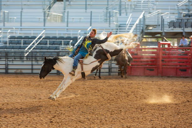 istock Cowboys Competing in the Bucking Bronco Event at a Rodeo 1053298592