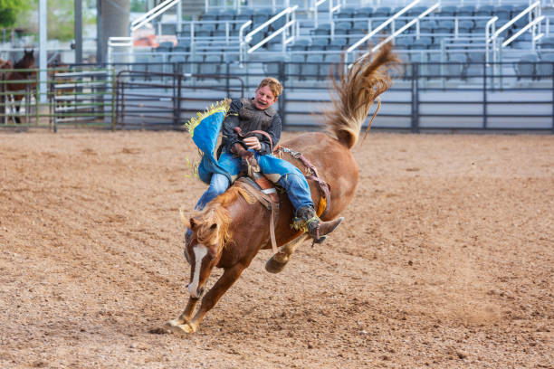 istock Cowboys Competing in the Bucking Bronco Event at a Rodeo 1053298626