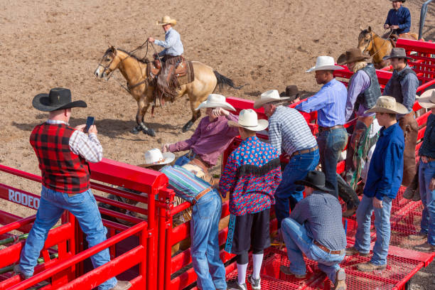 istock Group of Cowboys Watching a Rodeo 1053298704
