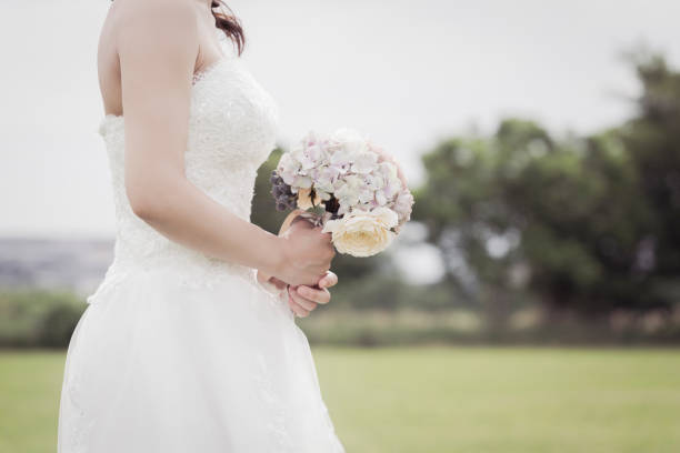 Asian woman wearing wedding costumes relaxed in the park.