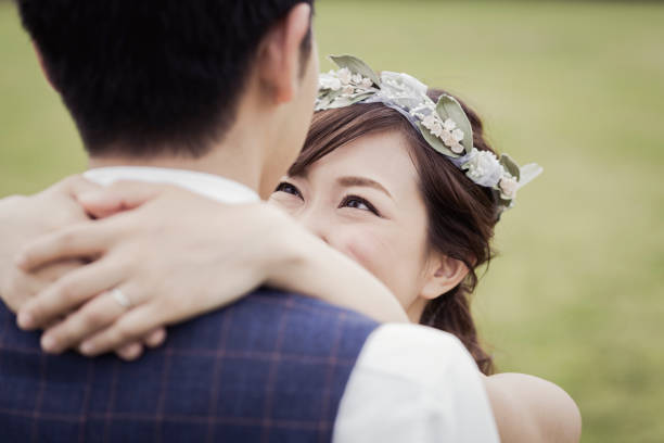 istock Beride and groom embracing in the green field 1053299142