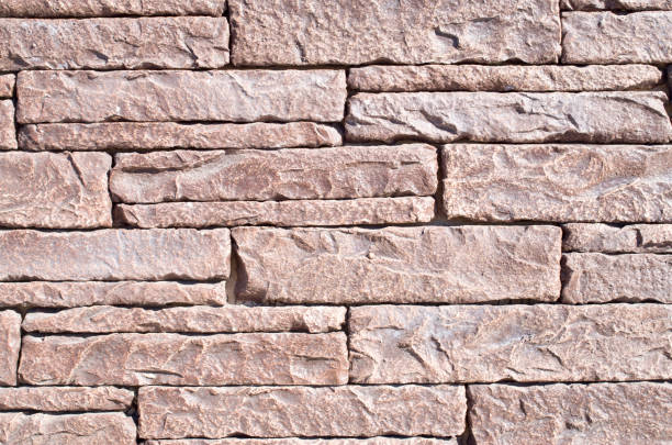 istock New brown  facade decorative  tiles on wall  imitating stone closeup 1053315644