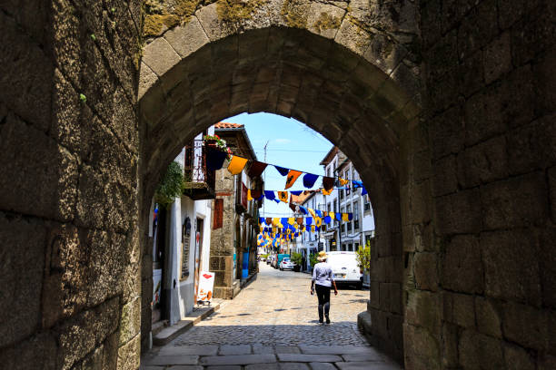 View of the ogival arch from inside the Kings Gate and the main street of the historic town of Trancoso, Portugal