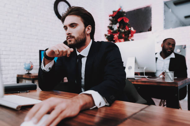 istock Upset Young Man Working in Office on New Year Eve. 1053317842