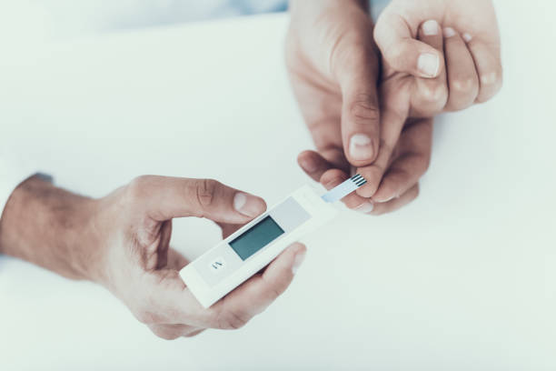istock Doctor Taking Blood Sample from Boy's Finger. 1053320348