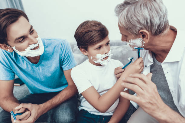 istock Grandfather, Father and Son Shaving Together. 1053320474