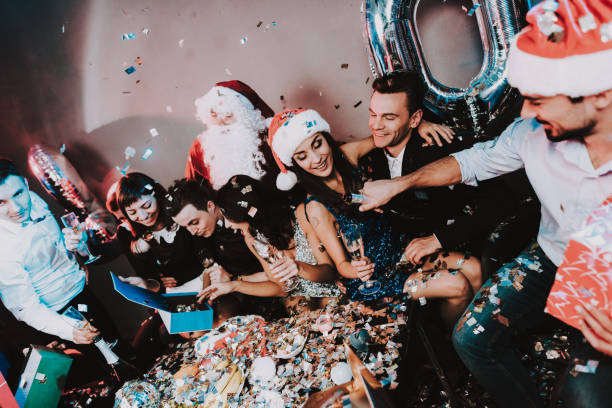 istock Young Happy People Celebrating New Year at Table. 1053322386
