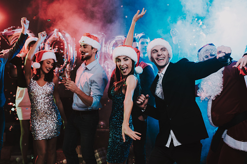 Happy Young People Dancing on New Year Party. Happy New Year. People Have Fun. Indoor Party. Celebrating of New Year. Young Woman in Dress. Young Man in Suit. Happy People. Modern Dances.