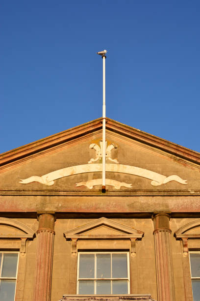 istock Old Town Building With Flag Pole and Seagull 1053322634