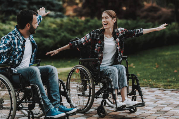 istock Disabled People on Wheelchairs Have Fun in Park. 1053322990