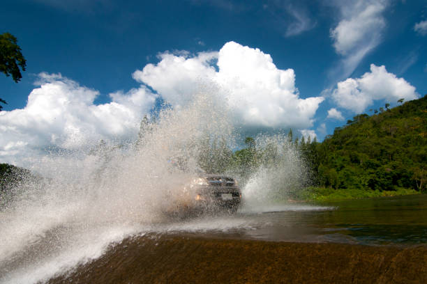 istock 4WD car wades river in suanphueng 1053327492