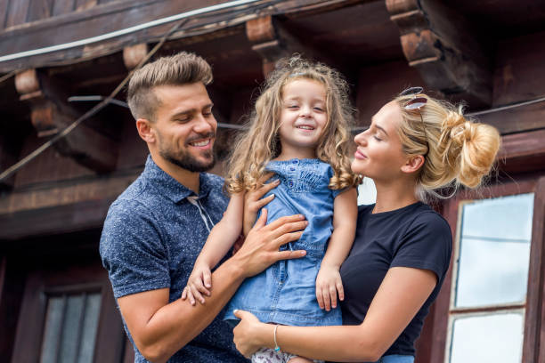 istock Happy family standing on the balcony 1053327810